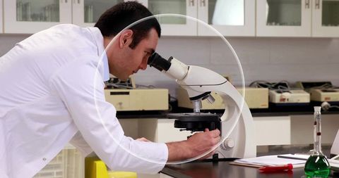 Scientist Adjusting Microscope in Modern Laboratory