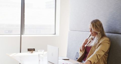 Focused Businesswoman Contemplating in Modern Office Lounge