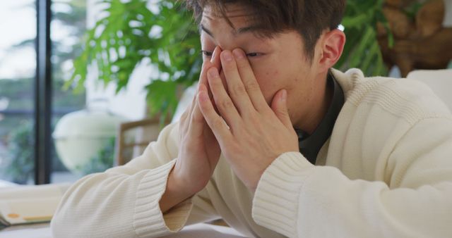 Tired Young Man Rubbing Eyes from Fatigue at Workspace - Download Free Stock Images Pikwizard.com