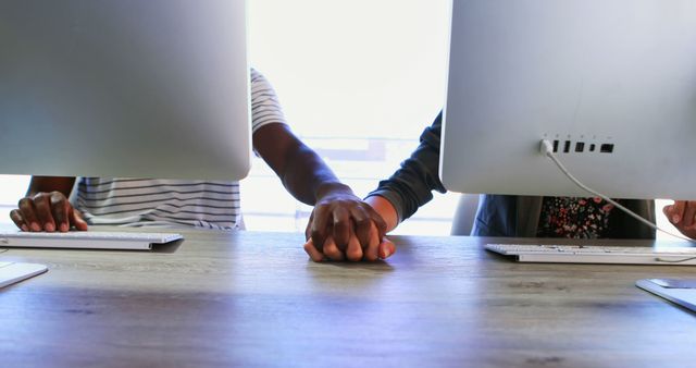 Closeup of office colleagues holding hands during work - Download Free Stock Images Pikwizard.com