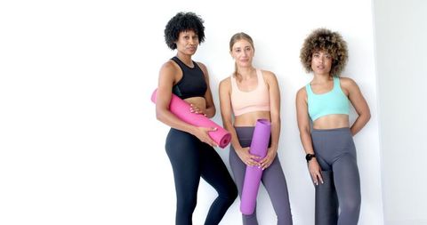 Diverse Women with Yoga Mats in Relaxed Workout Ready Pose