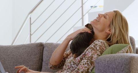 Woman Enjoying Quality Time with Her Cat on Couch
