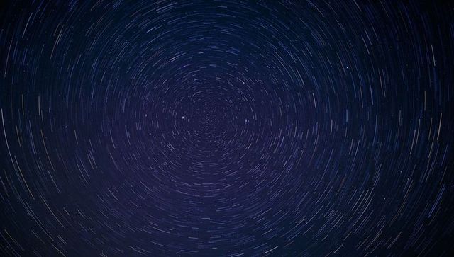 Concentric Star Trails Circling North Celestial Pole with Bright Polaris, Long-Exposure Night Sky