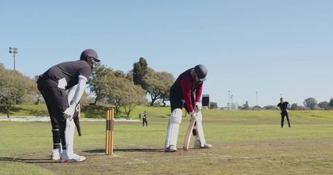 Cricket Players Preparing for Match in Bright Sports Field
