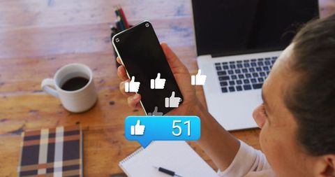 Caucasian Woman Receiving Likes on Smartphone in Home Office
