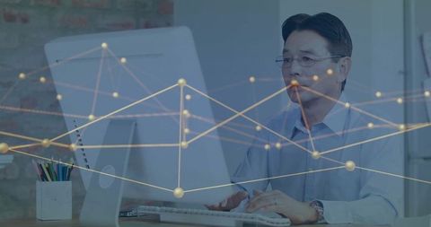 Focused Senior Man Engaged in Modern Office Workspace