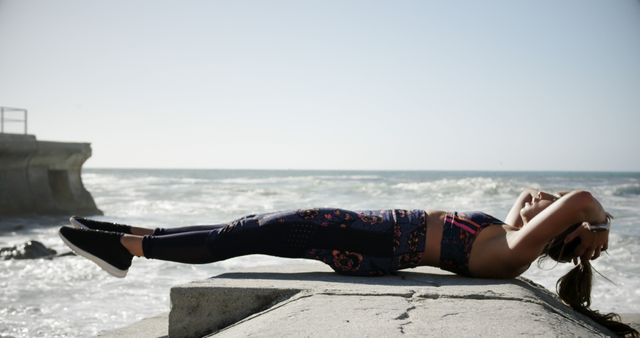 Young Woman Exercising Outdoors by Ocean Side - Download Free Stock Images Pikwizard.com
