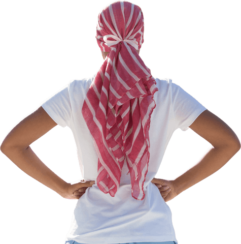 Confident Woman in White with Striped Headscarf Showing Strength Against Breast Cancer