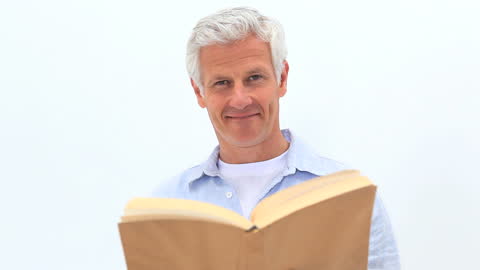 Smiling Mature Man Reading Book with White Background