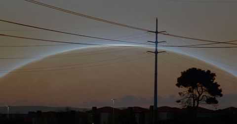 Digital Globe Overlay with Power Lines at Sunset