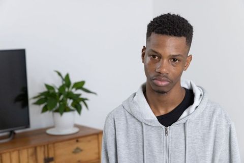 Thoughtful young man in urban minimalist living room