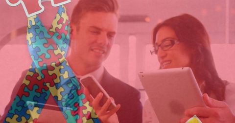 Autism awareness symbol over business people with tablets