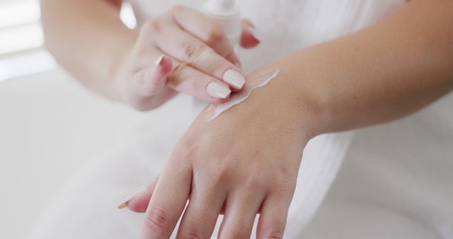 Woman applying moisturizer on hand skin care routine close-up - Download Free Stock Images Pikwizard.com