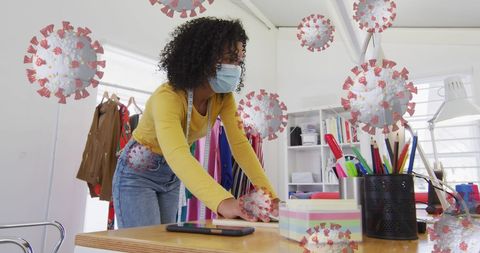 Woman in Office with Floating COVID-19 Cells Illustrating Safety Measures - Download Free Stock Images Pikwizard.com