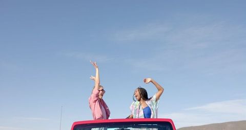 Joyful Women Celebrating Freedom on a Sunny Road Trip