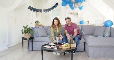 Mature Couple Celebrating Birthday in Cozy Living Room Setting