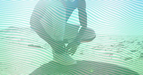 Silhouette of man contemplating rippled sand dunes