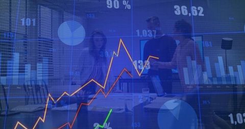 Business Team Analyzing Financial Data with Interactive Charts and Graphs in Modern Office