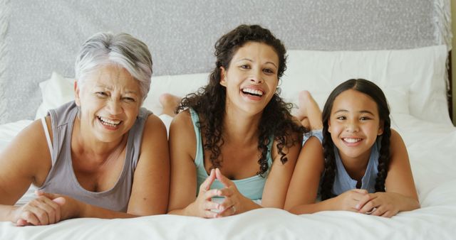 Multi-Generational Family Smiling and Relaxing in Bedroom - Download Free Stock Images Pikwizard.com