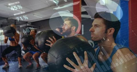 Man performing medicine ball squat in group fitness class with hud performance overlays