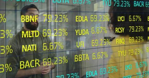 Professionals analyzing transparent stock ticker display in modern office