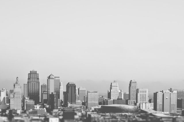 City skyline with modern skyscrapers captured in black and white. This monochrome image highlights the architectural details and the urban landscape. Ideal for projects related to urban planning, architecture, real estate, and editorial use featuring city life or business themes.