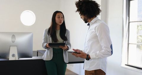 Multicultural colleagues collaborate in modern office environment