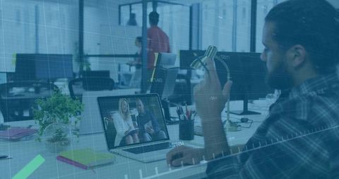 Bearded Man Conducting Virtual Meeting in Modern Office Context