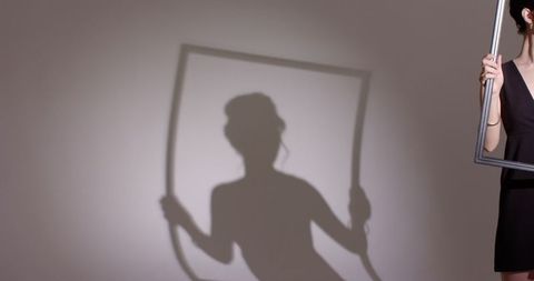 asian woman holding empty frame casting artistic shadow - Download Free Stock Images Pikwizard.com