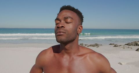 Serene African American Man Relaxing on Sunny Beachfront - Download Free Stock Images Pikwizard.com