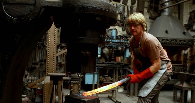 Blacksmith Working with Glowing Hot Iron Bar in Forge - Download Free Stock Images Pikwizard.com