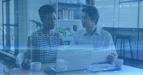 Coworkers collaborating on data analysis with laptop and digital analytics overlay