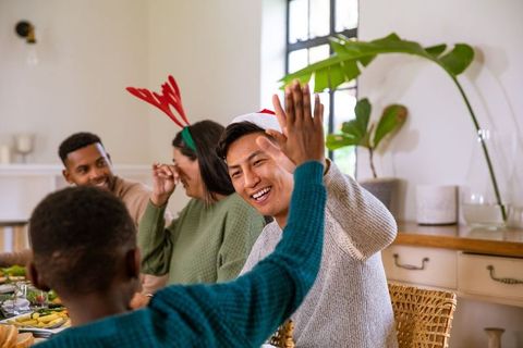 Festive Holiday Meal Celebration with Family High-Fiving