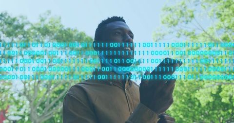 Holding Smartphone and Gazing Upward in Urban Park with Digital Binary Overlay