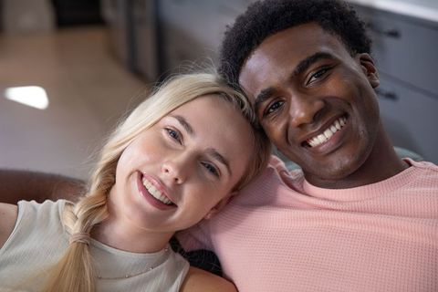 Happy Diverse Couple Relaxing Together at Home