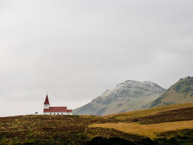 Lone red-roofed church on grassy hillside against background of misty mountains, offering serene, tranquil feel. Perfect for illustrating concepts of solitude, peace, spirituality, nature, countryside, travel promotions, Christian themes, or inspirational blog posts.