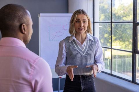 Colleagues Presenting Data and Ideas in Modern Office