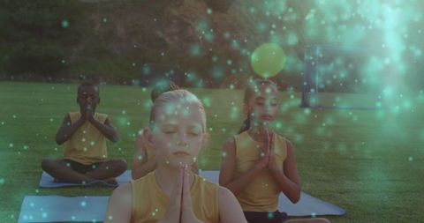 Children Meditating Outdoors with Magical Light Effect