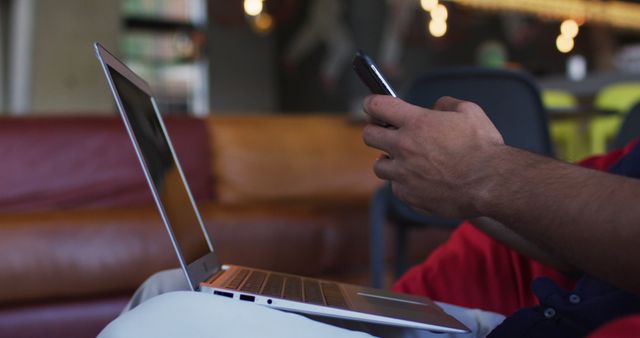 Person using smartphone and laptop in casual workspace - Download Free Stock Images Pikwizard.com