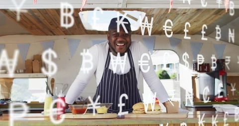 Smiling street food vendor presenting burgers and condiments at outdoor market stall