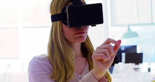 Young woman using VR headset interacting with virtual environment. Perfect for use in technological advancements, educational tutorials, gaming advertisements, and tech-focused articles.