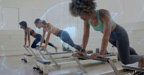 Women practicing pilates on reformers with futuristic overlay