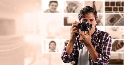 Male photographer holding slr camera in creative workspace