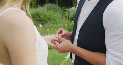 Diverse Couple Exchanging Rings at Outdoor Wedding