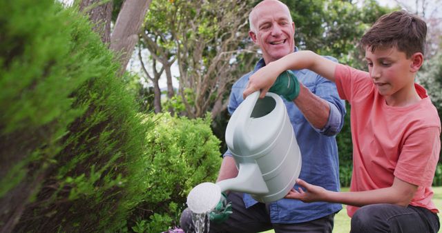 Grandfather and Grandson Watering Garden Together - Download Free Stock Images Pikwizard.com