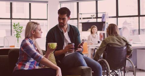 Modern Inclusive Office: Coworkers Collaborating in Lounge