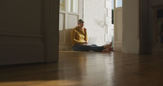 Senior Woman Working Remotely at Home with Laptop in Cozy Sunlit Room - Download Free Stock Images Pikwizard.com