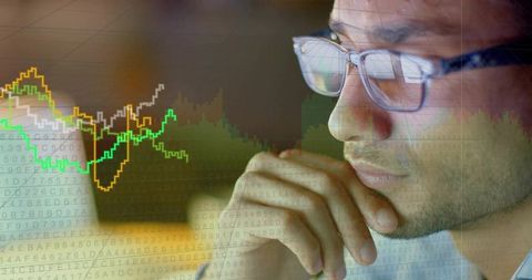 Data analyst analyzing market charts reflecting in glasses, contemplating financial trends