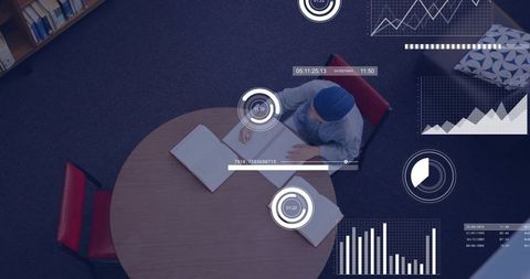 Overhead student studying with notebooks and digital analytics overlays in library