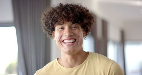 Smiling Young Man Radiating Happiness at Home - Download Free Stock Images Pikwizard.com
